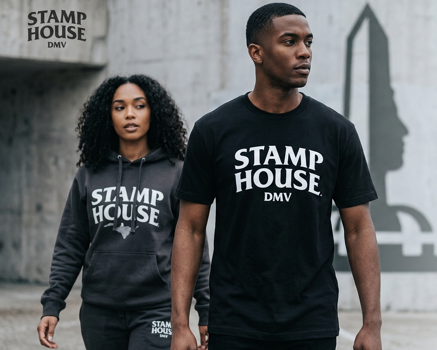 Two people wearing 'Stamp House DMV' streetwear with a promotional message on a gray STREET CITY background.